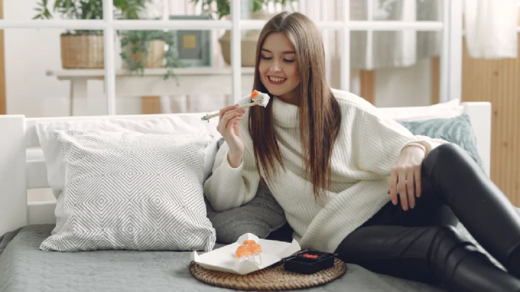Pregnant woman eating safe vegetable sushi rolls
